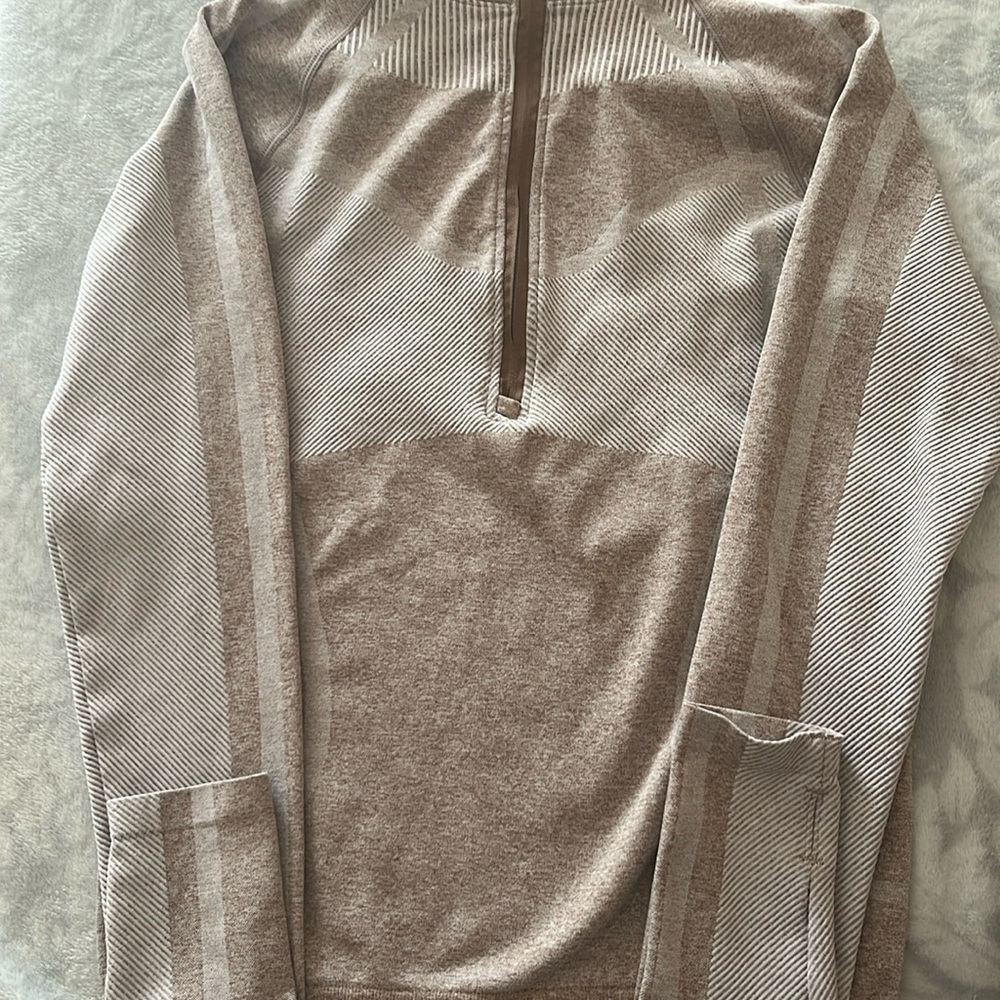 I’m selling a kids half zip up top sweater it is a light pink never worn zip up.